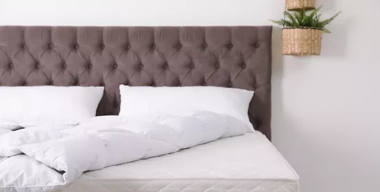 Comfortable bed with white pillow.