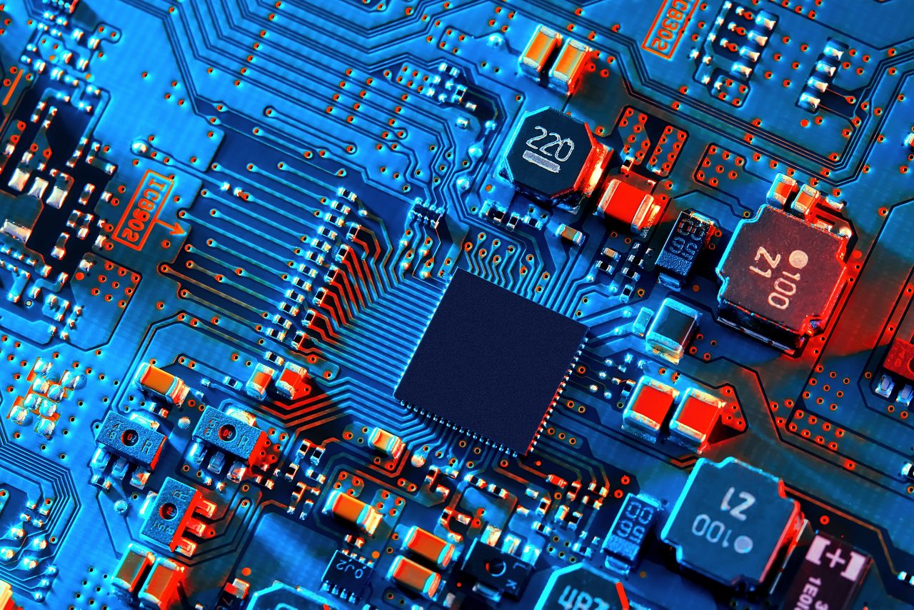 Blue electronic circuit board close up.