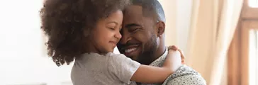Dad and kid hugging