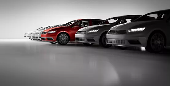 Compact cars fleet in the studio garage with a red one standing out. 