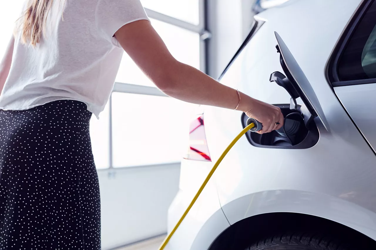 White car parked in a public EV charging station