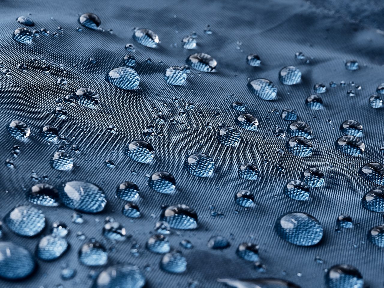 gotículas de água em tecido azul impermeável 