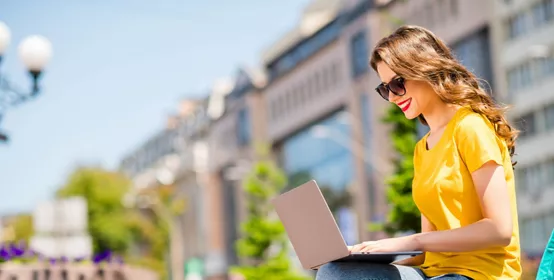 Profile side view portrait of her she nice attractive lovely pretty cheerful cheery, confident girl working remotely on digital laptop creating presentation downtown on fresh air outdoors