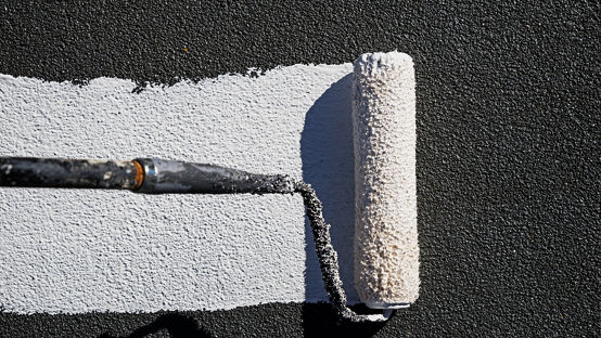 Painting a roof with reflective white elastomeric coating