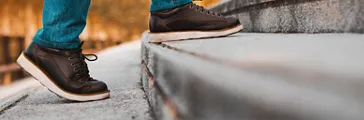 Person walking up steps in casual shoes