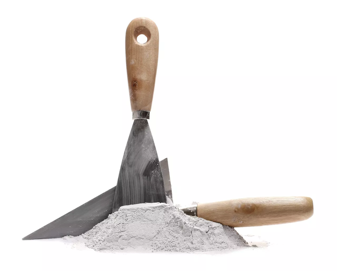 Closeup of redispersable latex powder in a pile surrounded by construction tools for cement.