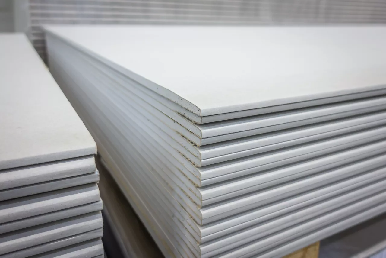 Stack of gypsum boards prepared for construction.