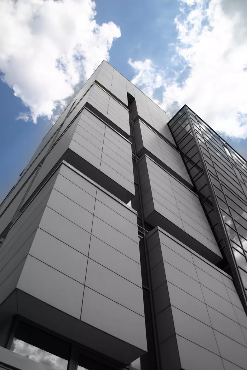 ground-up view of grey tiles on side of building 