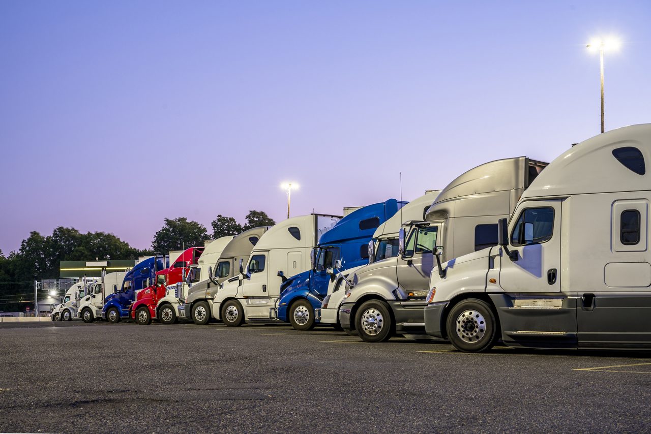 Line of different big rigs semi trucks
