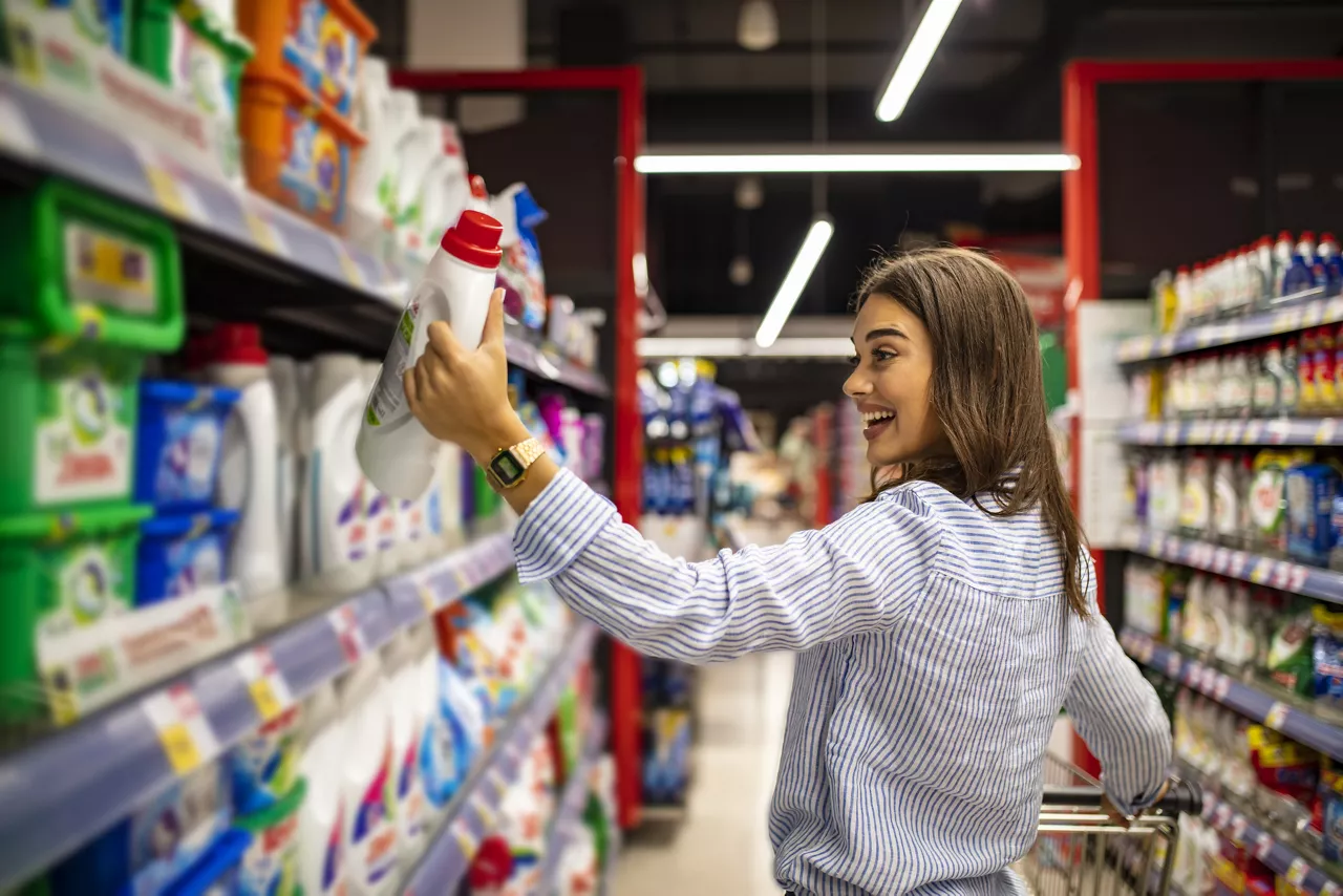 Woman holding package at grocery store 