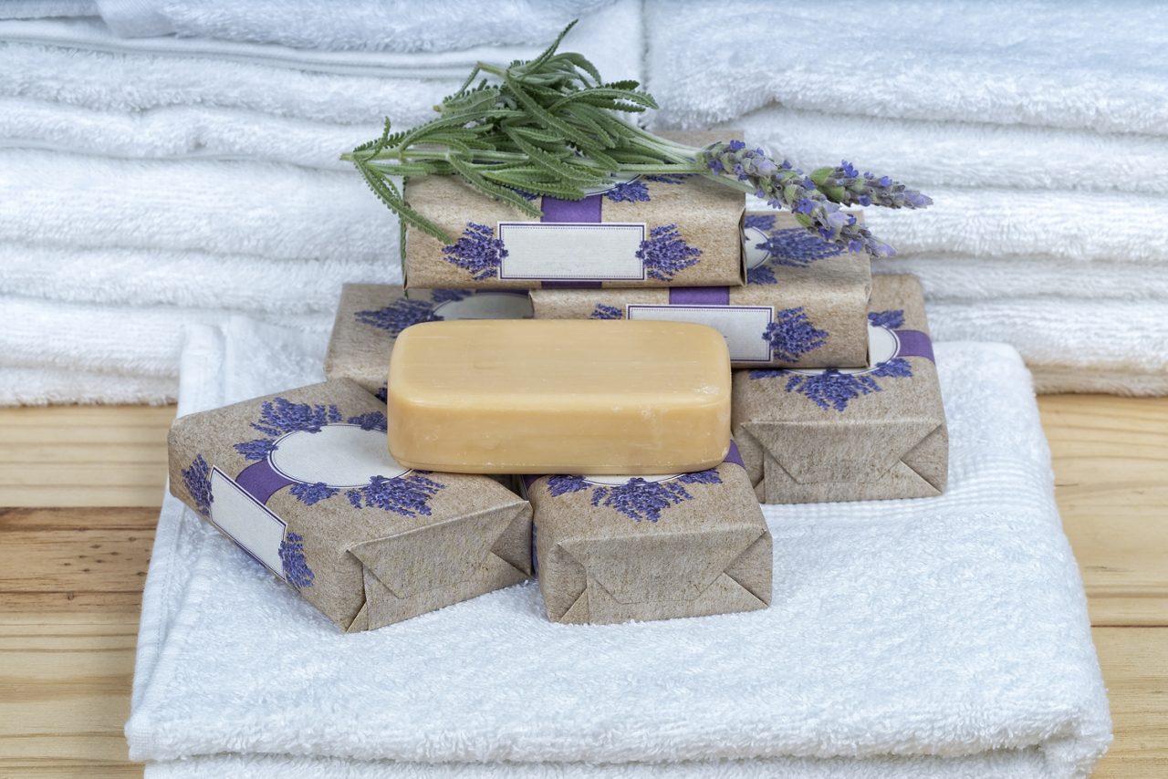 Handmade lavender soap tablets eco friendly and with white towels in the background.