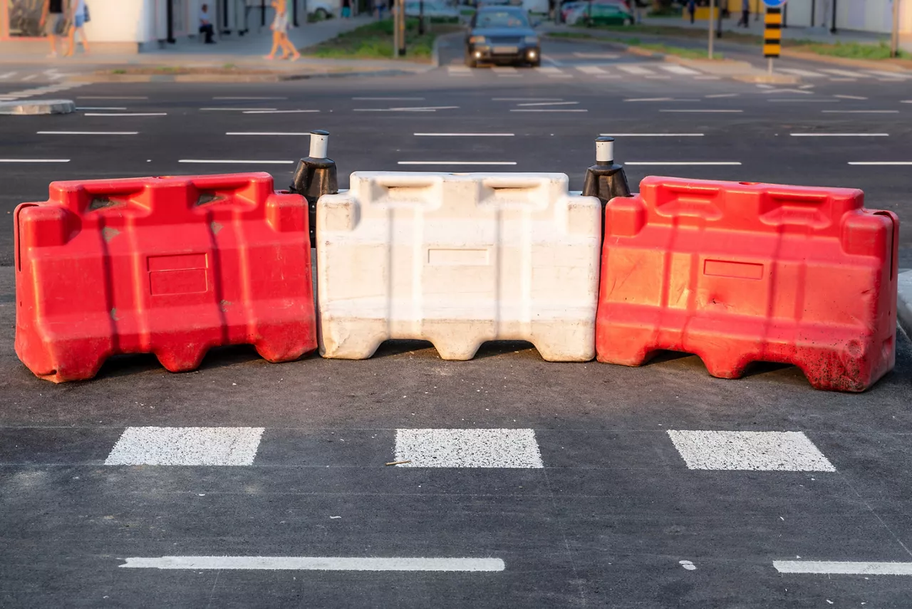 White and red plastic road safety barriers