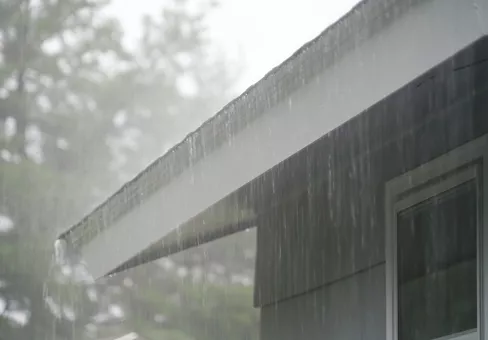 Heavy rain falling on rooftop