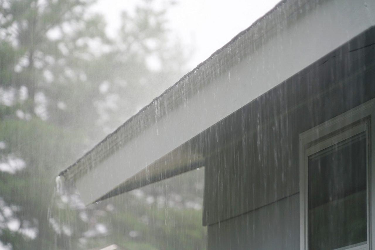 Heavy rain falling on rooftop