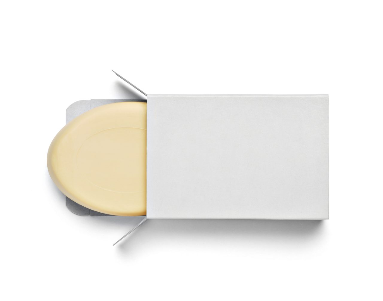 close up of  a white soap bar in a box on white background