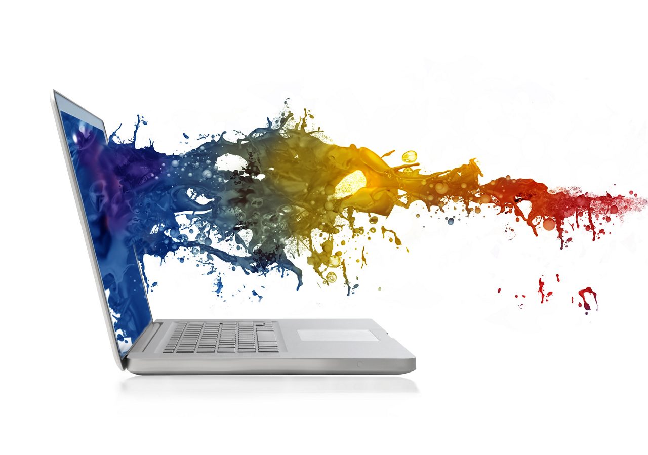Tela de computador explodindo com tinta colorida