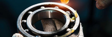Mechanic is putting yellow grease in the into bearing, engineering and industrial concept