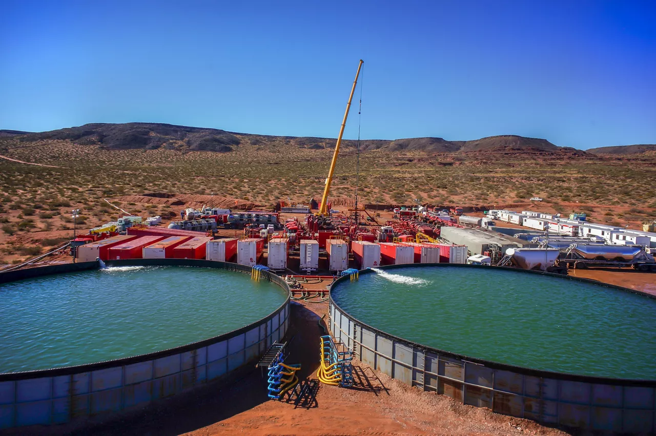 Vaca Muerta, Argentina, August 26, 2014: Extraction of unconventional oil. Battery of pumping trucks for hydraulic fracturing (Fracking).