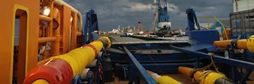Cable-laying vessel lays cable at sea