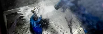 Person washing metal parts 