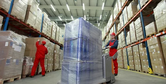 Warehouse worker moving a pallet of goods.