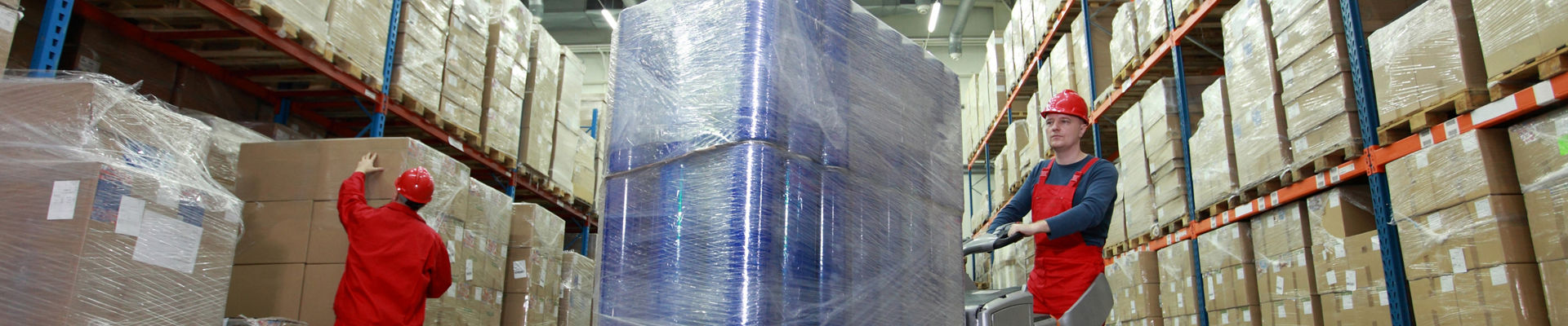Employee moving a pallet of products wrapped in stretch film