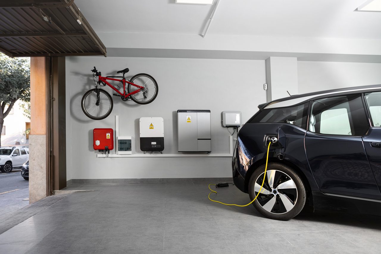 EV in garage plugged into residential charging station