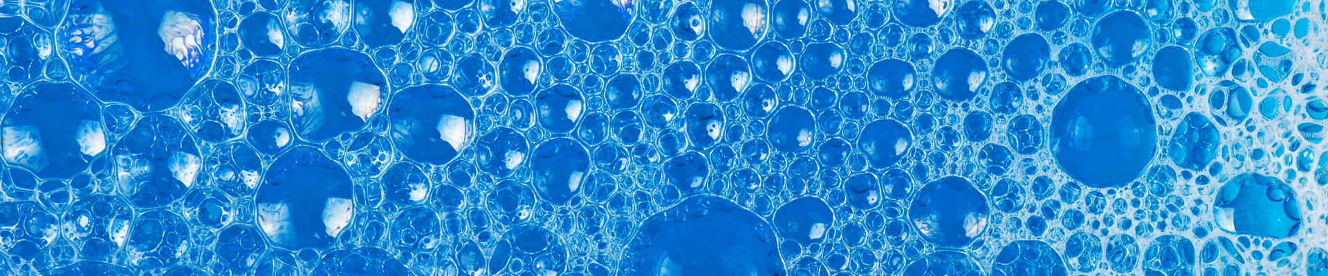 Clear foam bubbles in blue liquid