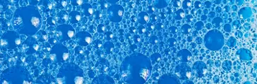 Clear foam bubbles in blue liquid