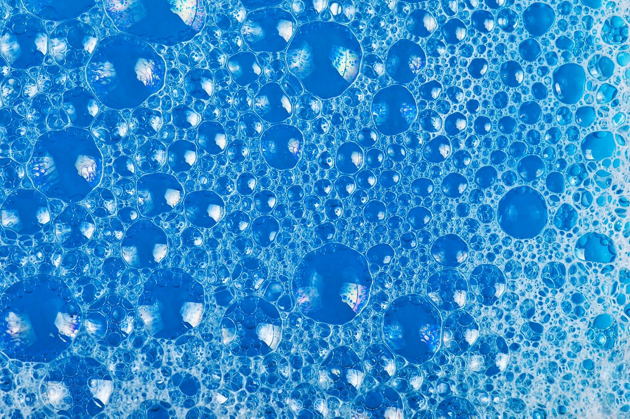 Clear foam bubbles in blue liquid