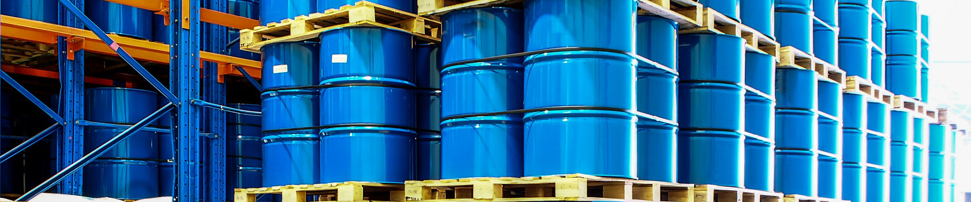Blue industrial drums on warehouse shelves