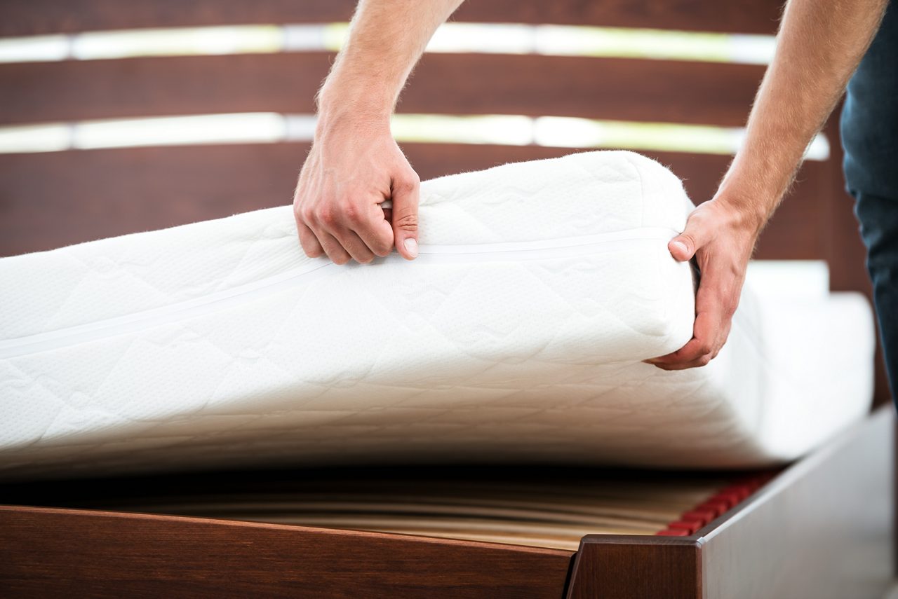 Close up photo of young man demonstrating quality of mattress
