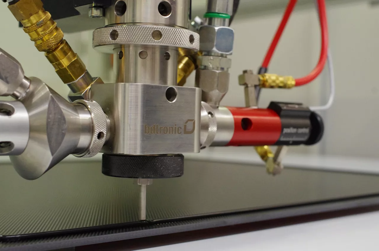 Silicone gray foam being dispensed in groove by machine