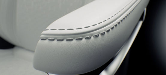 Automotive interior armrest with off-white silicone synthetic leather and stitching