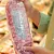 Person holding large portion of meat in packaging at grocery store