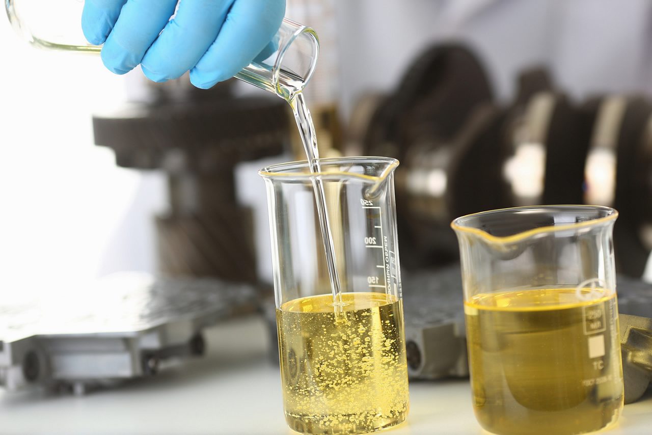 Pouring liquid into lab beakers
