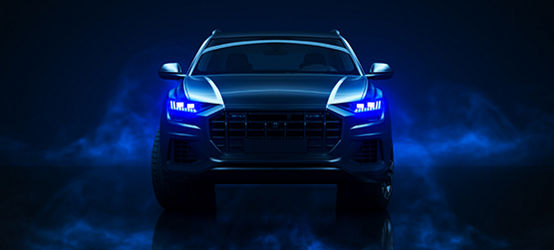 Front of car with blue LED lights and atmospheric smoke appearing on side of car