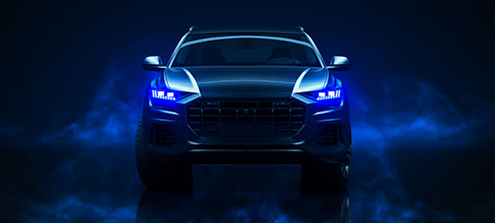 Front of car with blue LED lights and atmospheric smoke appearing on side of car