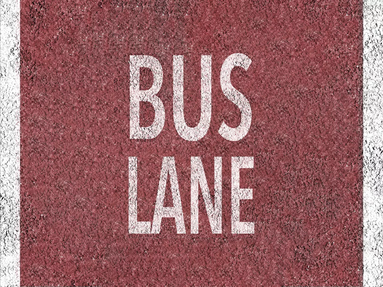 Red bus lane marked on asphalt