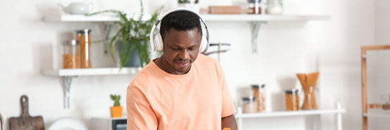 hombre escuchando música mientras limpia su cocina