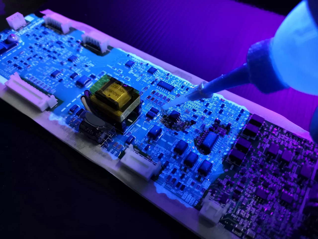 Cip board under uv light; Shutterstock ID 1135041149; Cost Center: 194847  ; Project: Conformal Coatings Selection Guide; Client/Contact: Dow; WO/Notes: Rebecca S McLaurin