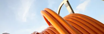 Orange cable on iron drum