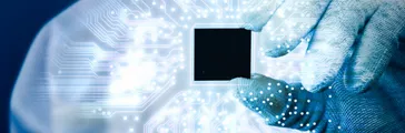 Engineer holding electronics chip and electronics