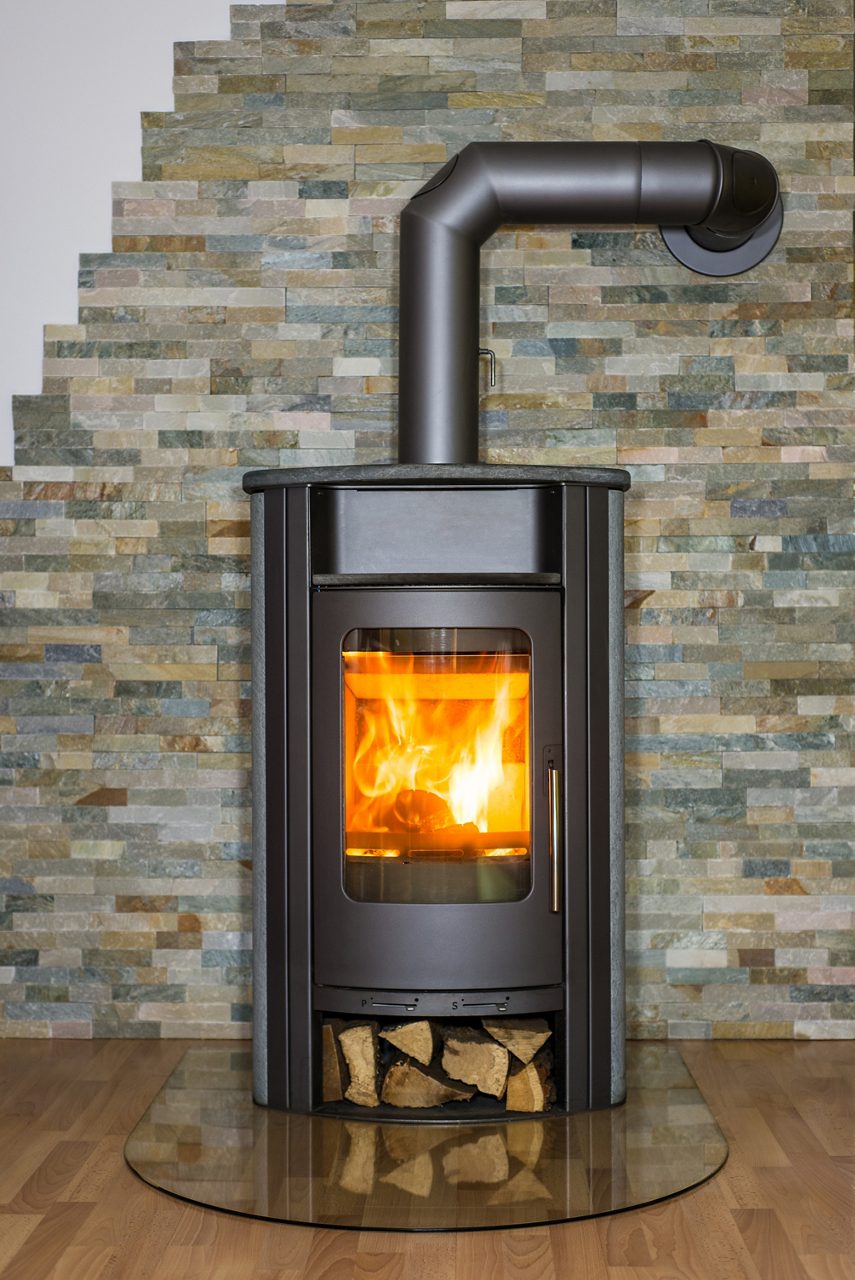 Roaring fire inside wood burning stove in living room; Shutterstock ID 233210923; Cost Center: 195854; Project: web/banner print; Client/Contact: DOW; WO/Notes: Levecq, Marie - Melanie