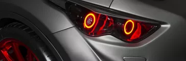 red car headlight and hood of powerful sports car