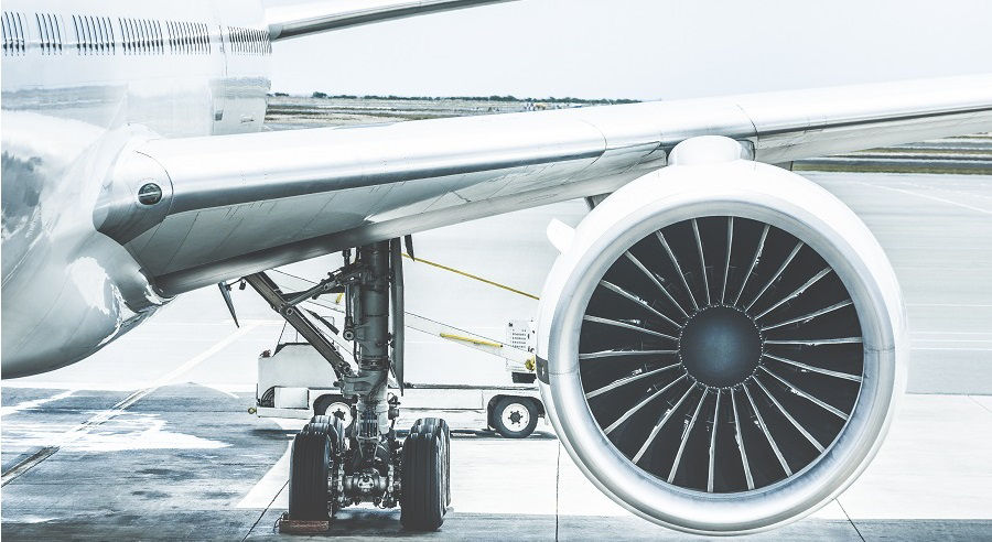 Detail of airplane engine wing at terminal gate before takeoff - Wanderlust travel concept around the world with air plane at international airport - Retro contrast filter with light blue color tones