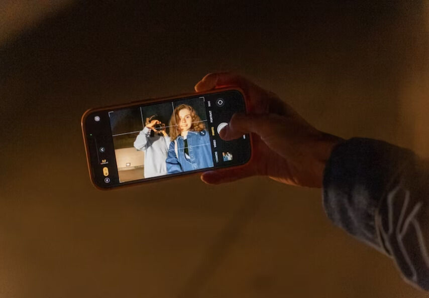 Person Holding an iPhone taking a picture