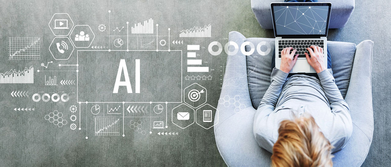 AI with man using a laptop in a modern gray chair