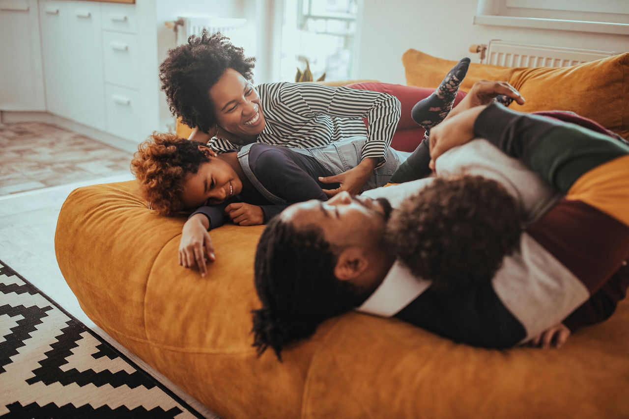 Mother and father playing with their children at home