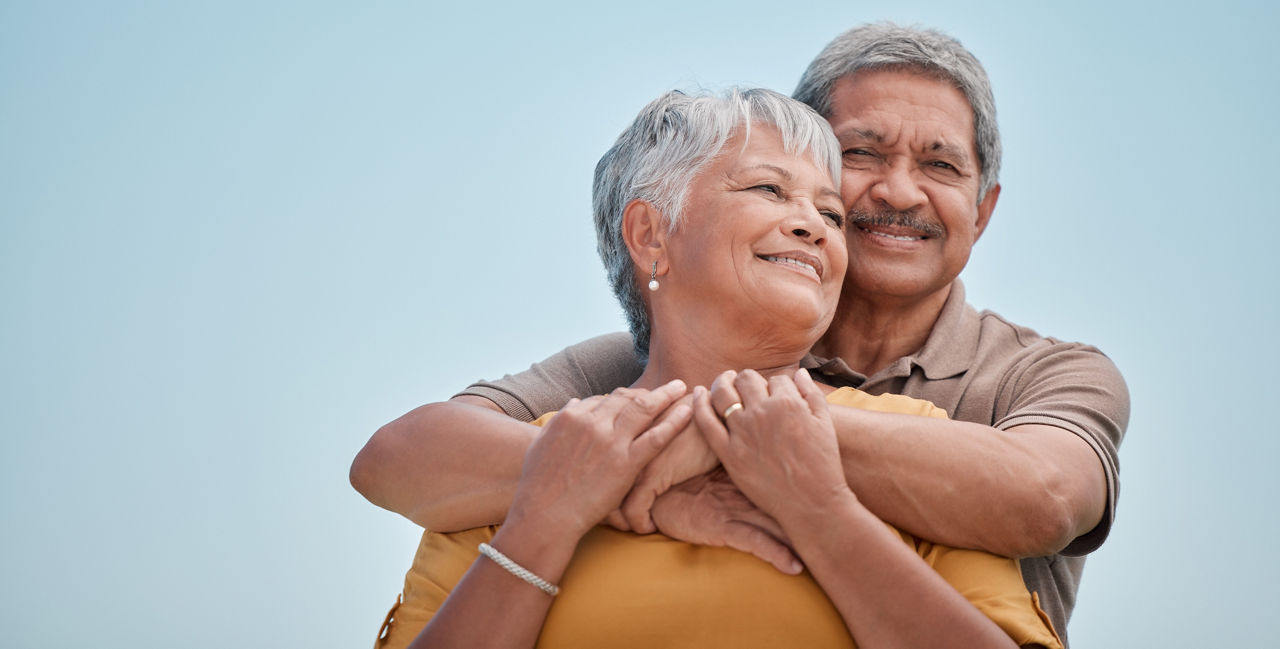 Love, senior couple and hug being happy together, bonding and embrace for anniversary, marriage and smile. Romantic, elderly man and woman celebrate relationship, for romance or loving for happiness